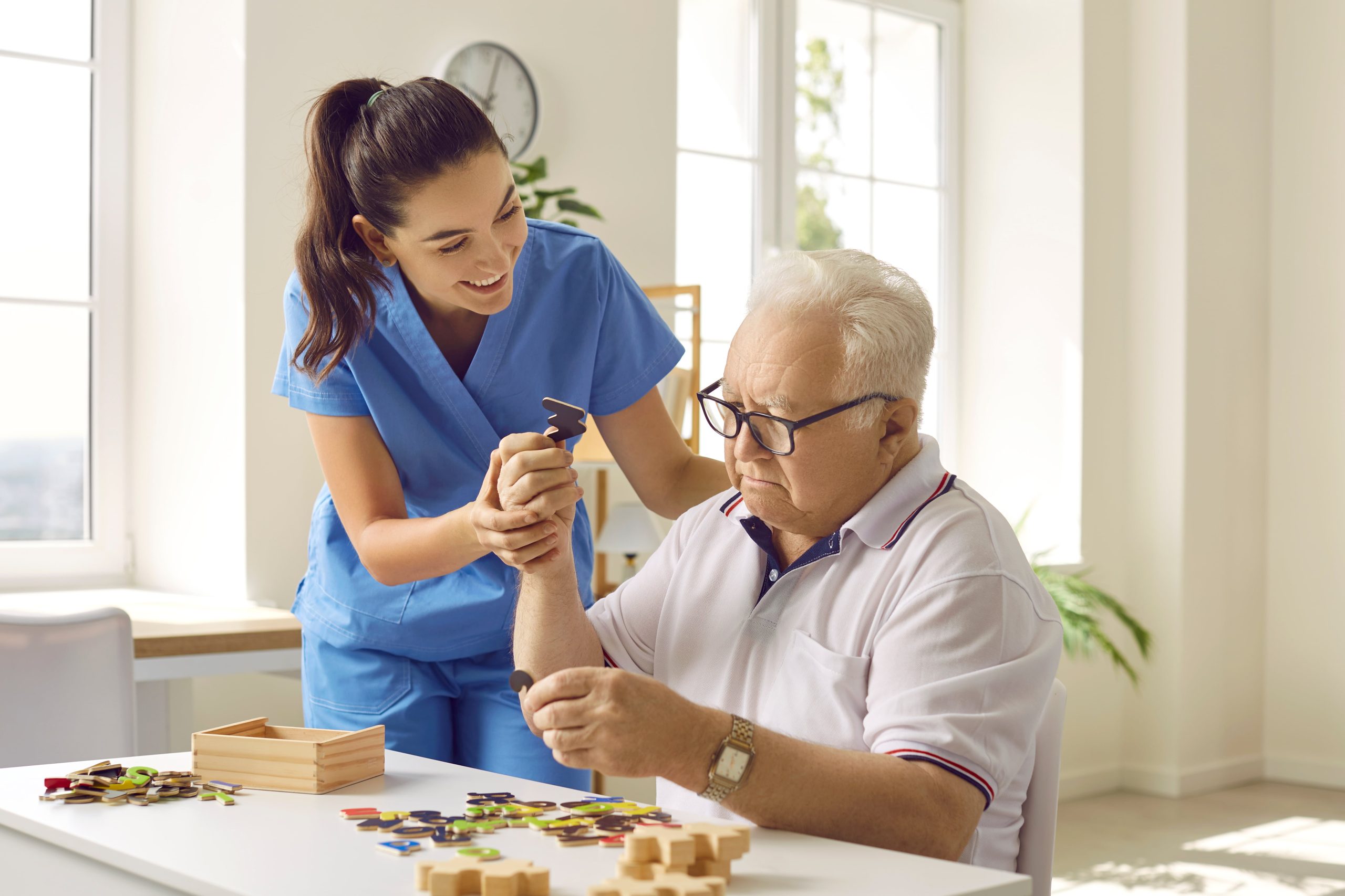caregiver elderly man puzzles