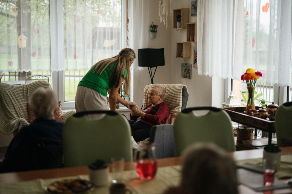 Caregiver helping elderly person at home in Florida