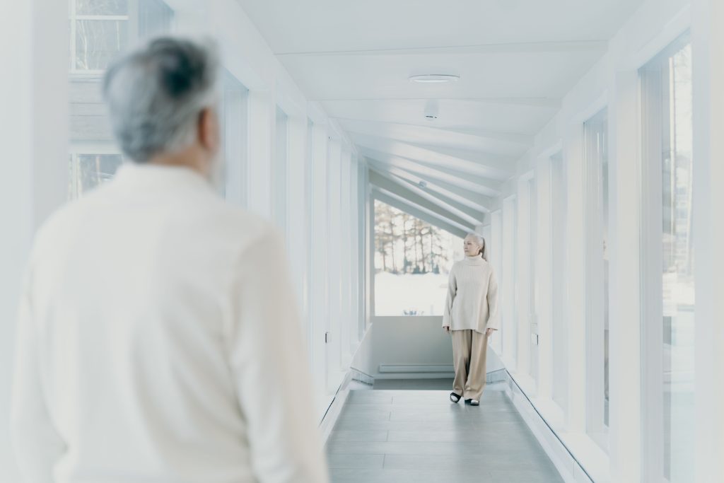 shadowing elderly woman following hallway