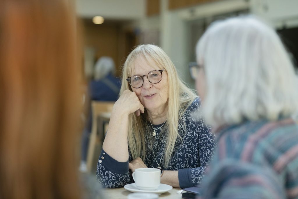 A companion walking with an older man, one of the signs your loved one may need a dementia companion is isolation