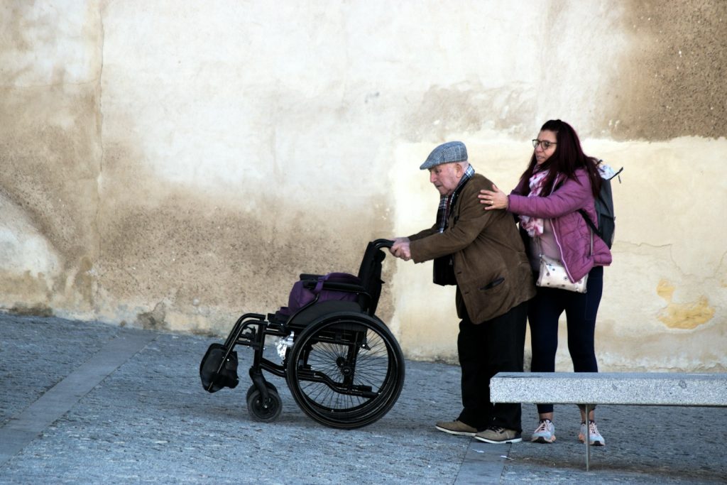 A visiting nurse and a family member at home, showing the home health care side of companion care vs home health care