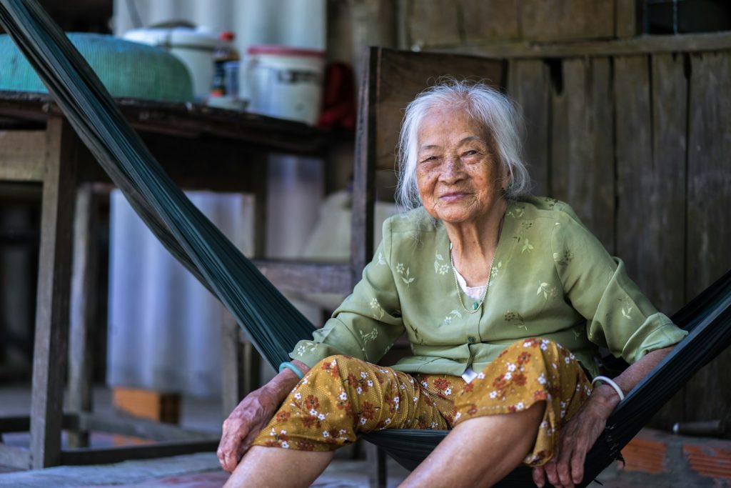 Residents sharing a meal in a dining room, the assisted living side of in-home care vs assisted living