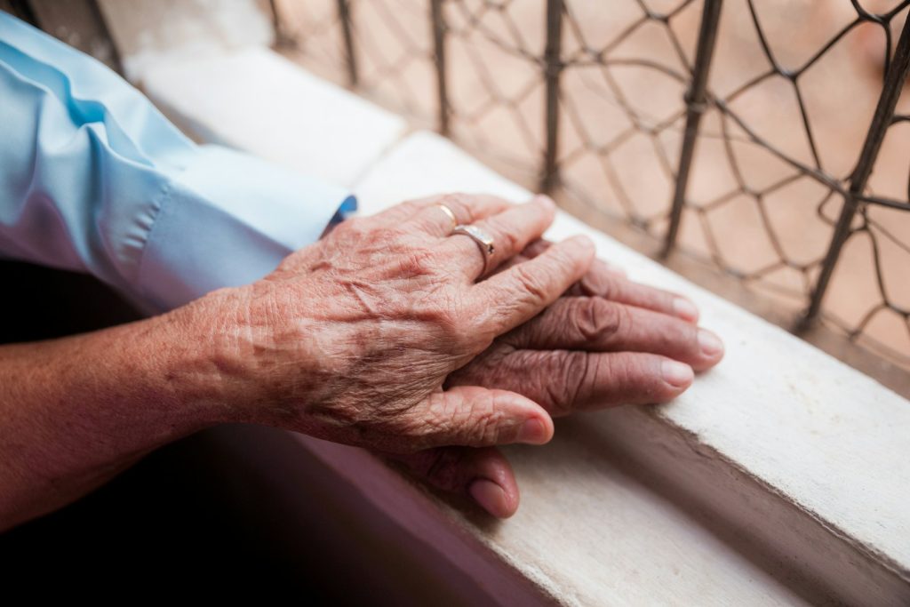 A nurse checking on an older resident, the skilled side of memory care vs nursing home