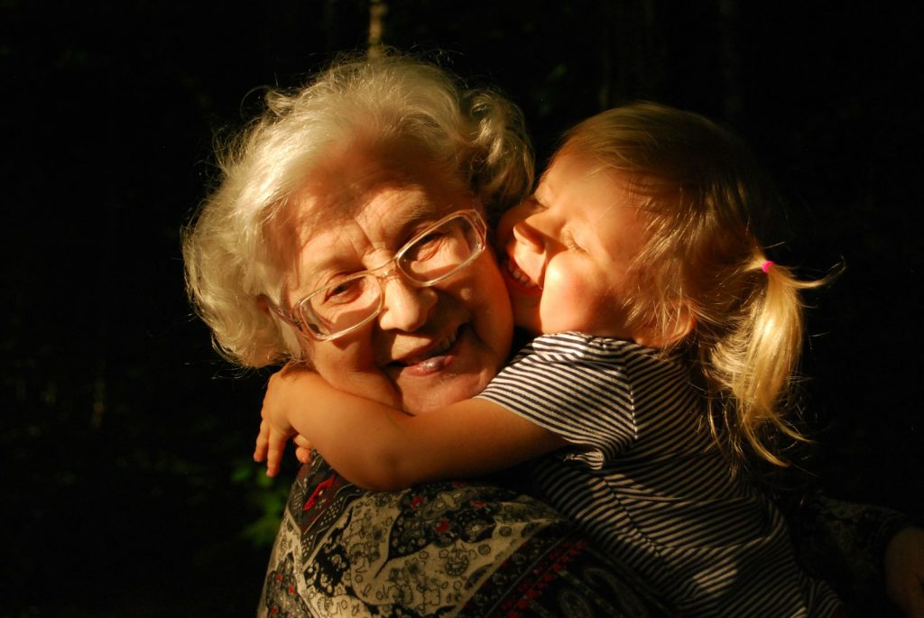 Helping a parent with dementia and hearing loss by checking hearing aids together each morning