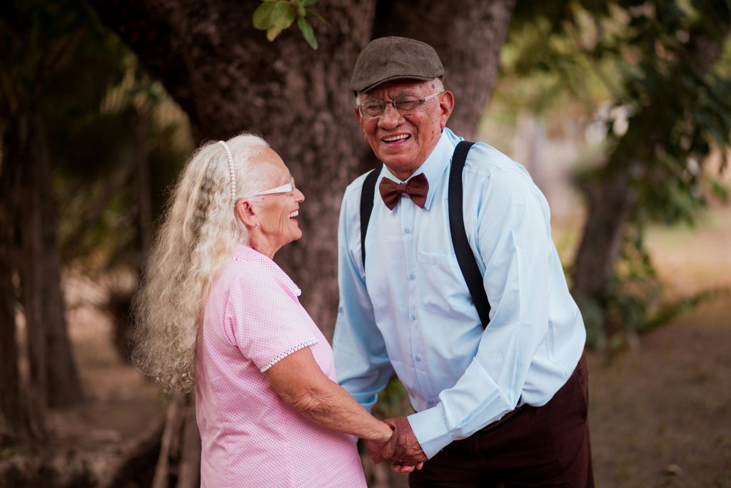 A companion and an older man looking through a photo album, an example of dementia care for one family's situation