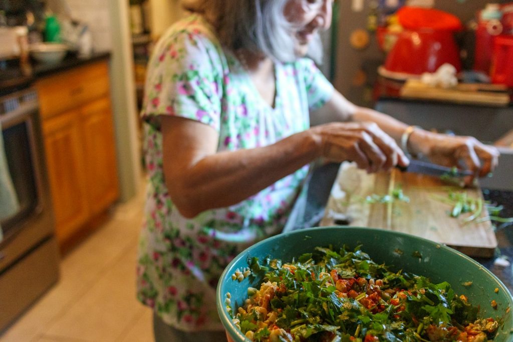 Help with activities of daily living at home: a companion helping an older man choose clothes