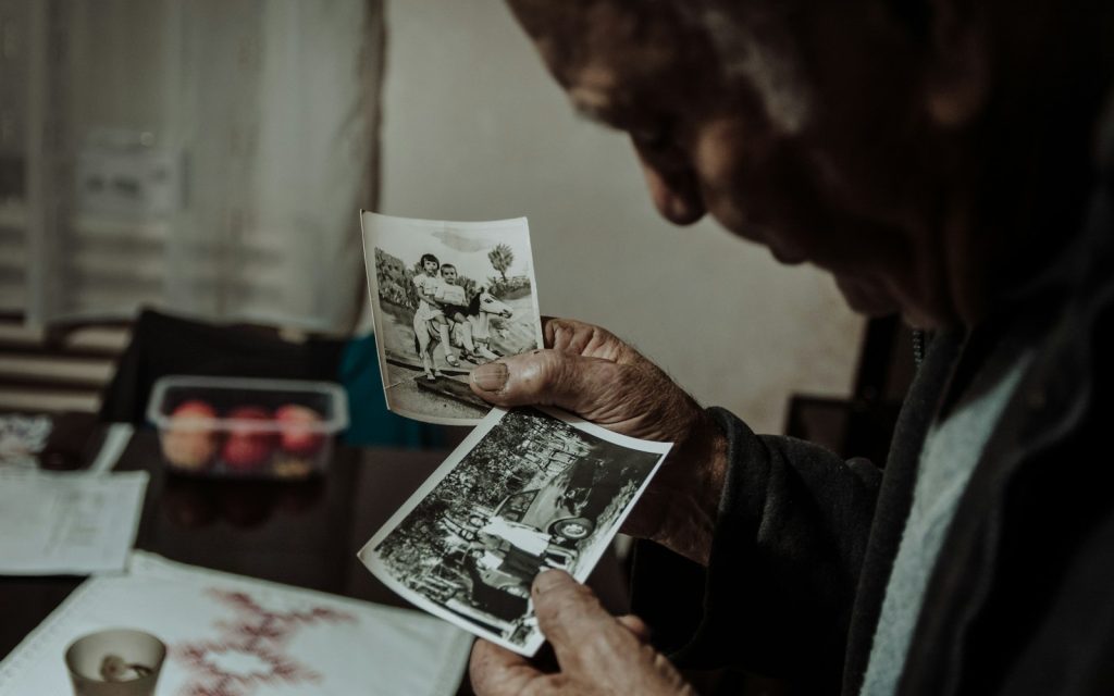 Living with Alzheimer's disease: a companion and an older man walking in a sunny park