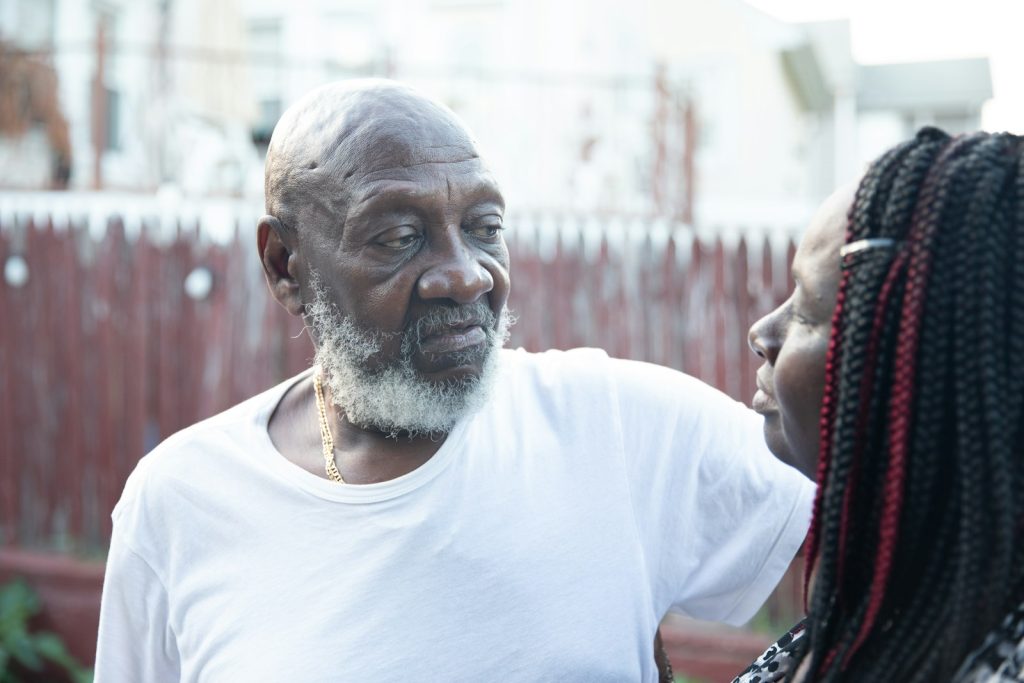 Helping a loved one recover from delirium: a companion offering water to an older man at home