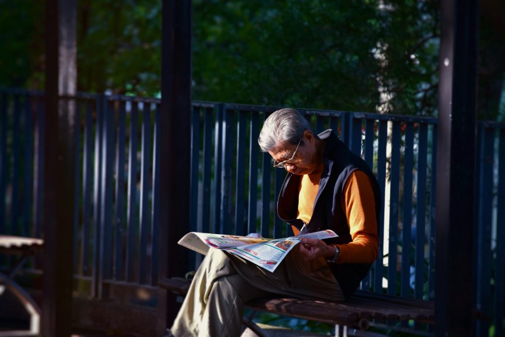 Lewy body dementia care at home: a companion helping an older man stand up slowly from a chair