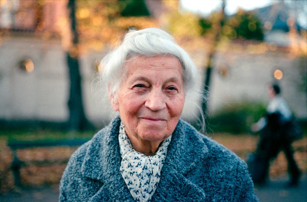 Dementia care hours at home: a companion and an older woman looking at photos together