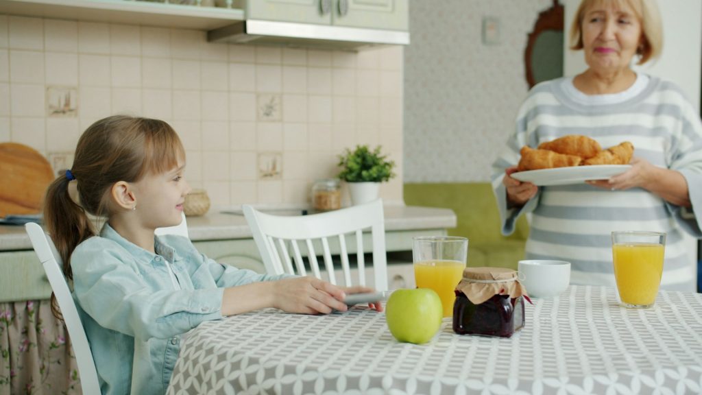 Adult daughter planning in-home dementia care cost with a calculator and calendar
