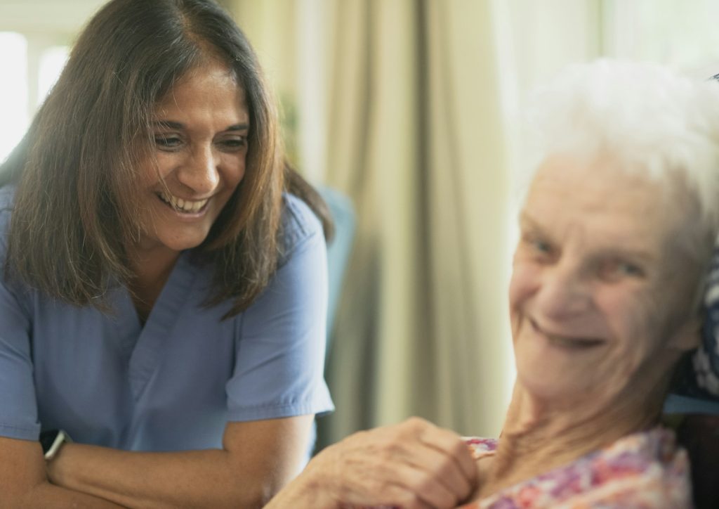 A family asking a caregiver about her Florida ADRD training