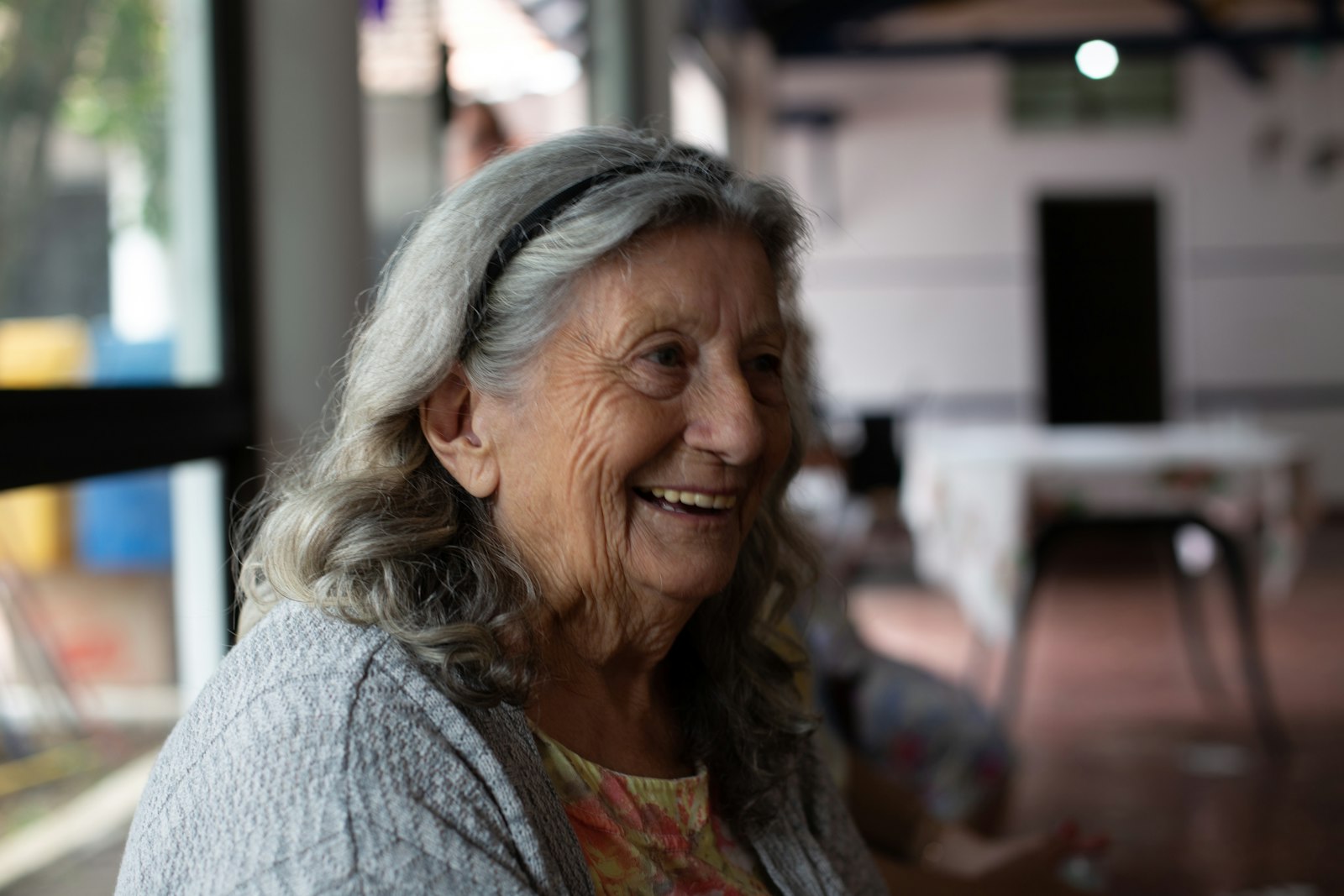 An older woman smiling during a relaxed conversation