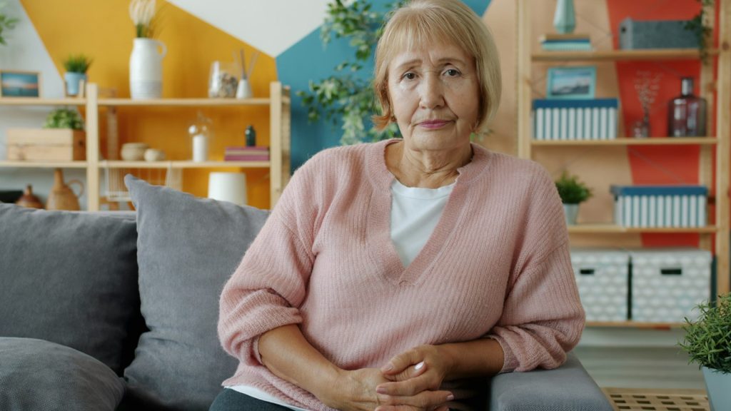A companion and an older man listening to music during in-home dementia care