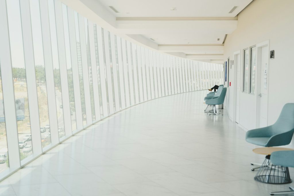 Dementia in the hospital: a daughter holding her mother’s hand for reassurance