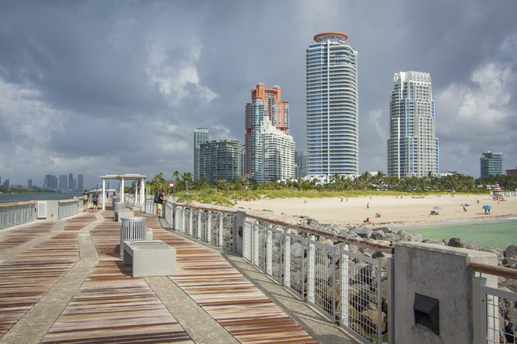 A companion providing dementia home care in Miami Beach, playing cards with an older woman in her condo