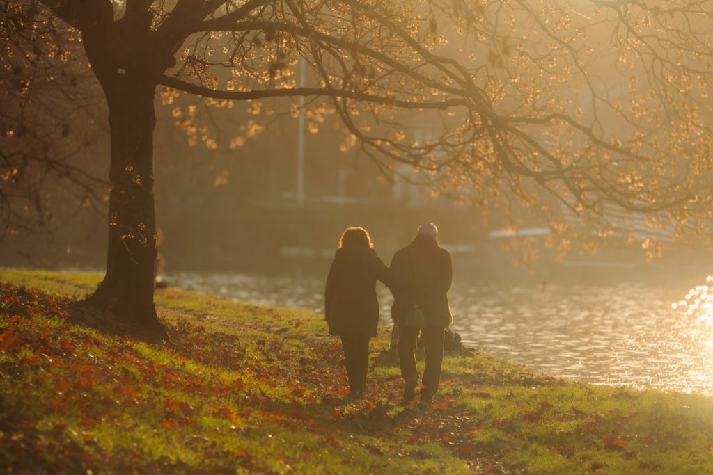 A companion providing dementia home care in South Miami, walking with an older woman in a neighborhood park