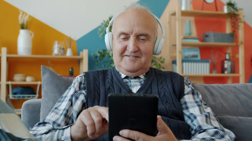 Music for dementia: an older man smiling while listening to a favorite song