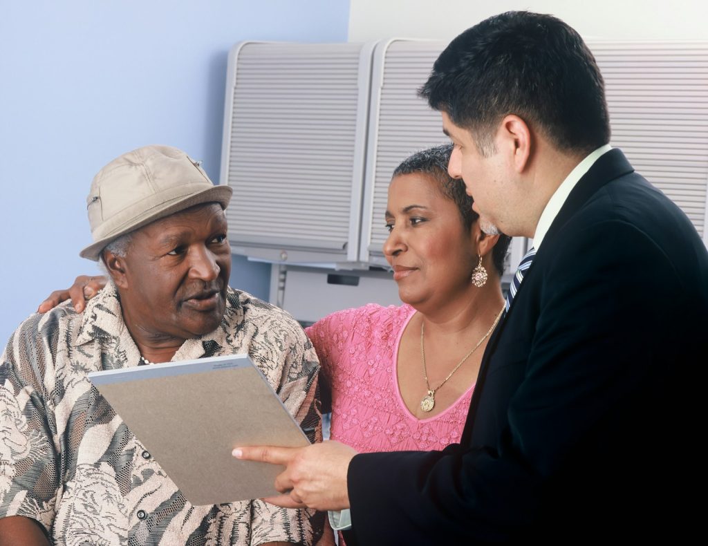 A family caregiver filling in a long-term care insurance claim form for a parent with dementia (long-term care insurance)