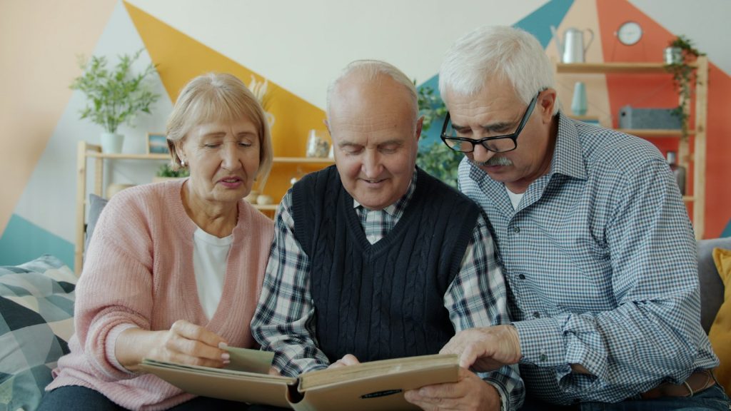 Memory disorder clinic Florida: an older couple and a relative looking through a folder