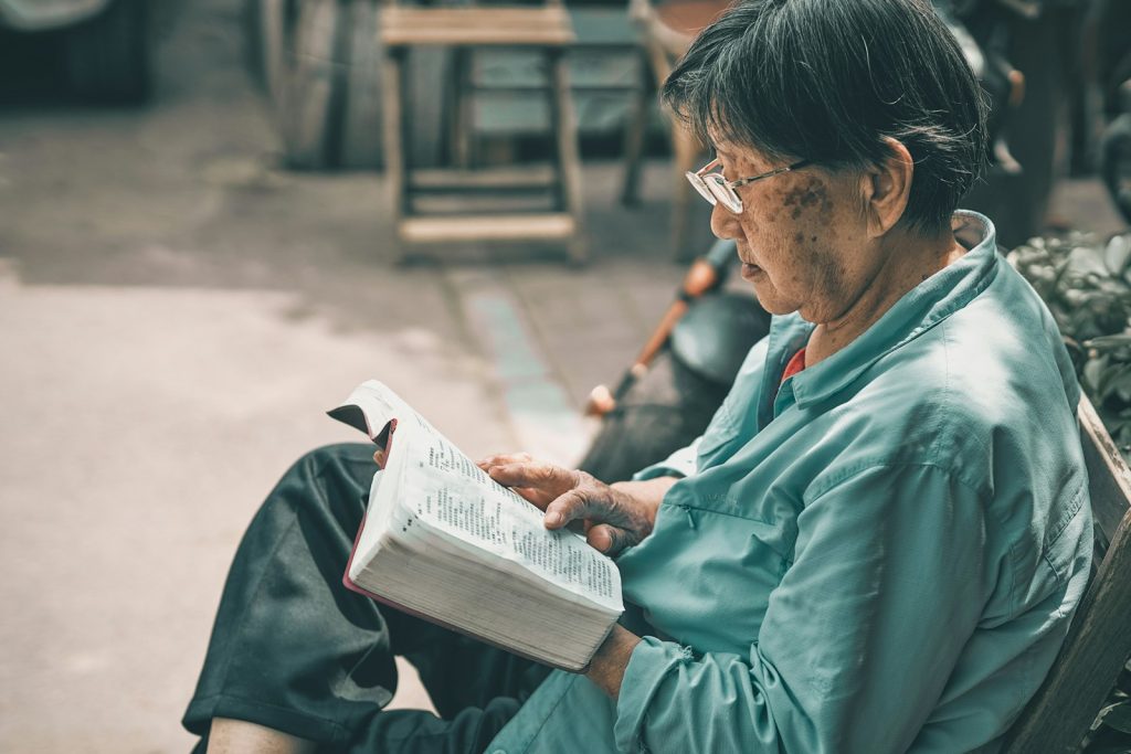 A family caregiver filling in a long-term care insurance claim form for a parent with dementia