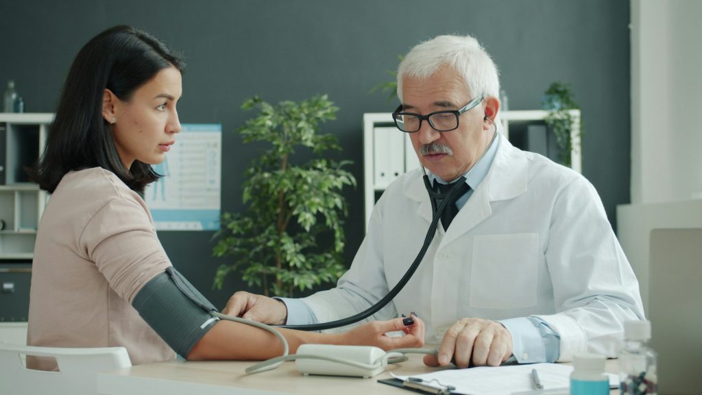 an older man and his daughter talking with a doctor about a care plan (does Medicare cover dementia care)