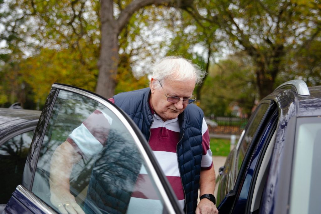 A daughter and her father talking at the kitchen table after a dementia diagnosis, including when to give up the car keys