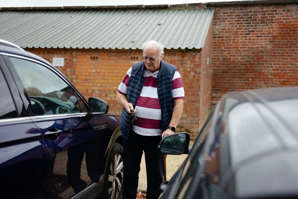 Deciding when to stop driving with dementia: an older man holding his car keys beside his daughter