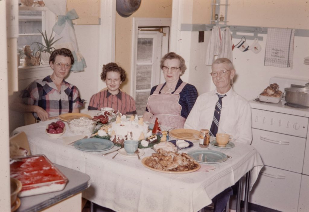 A family gathered around the dining table, the kind of household where dementia care in Riverview fits around busy schedules