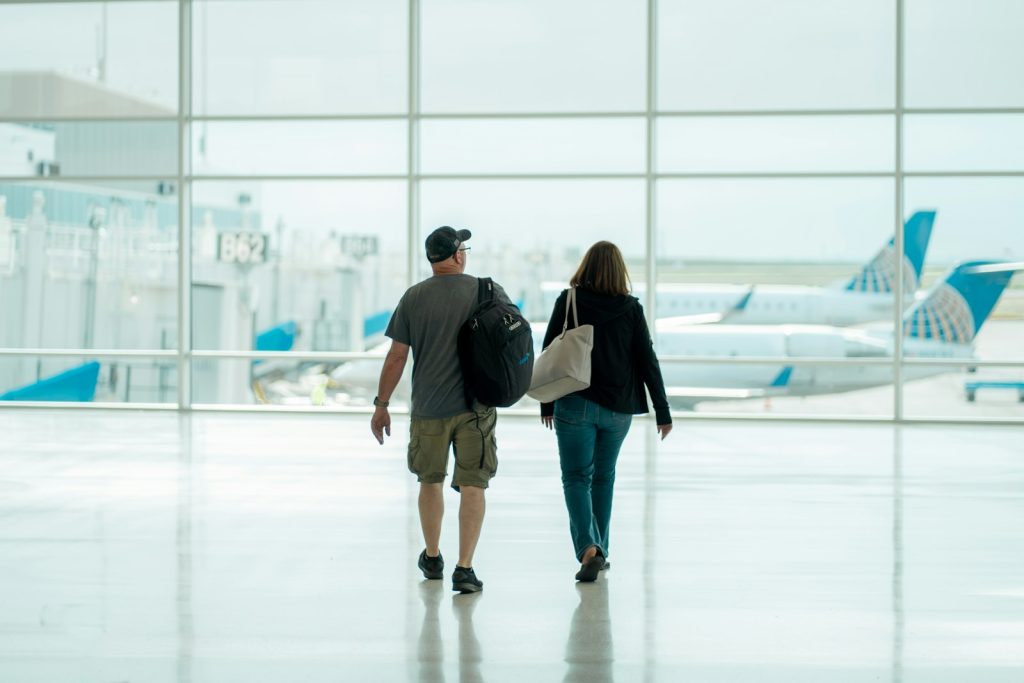 Traveling with dementia: a daughter walking with her older father through a calm airport