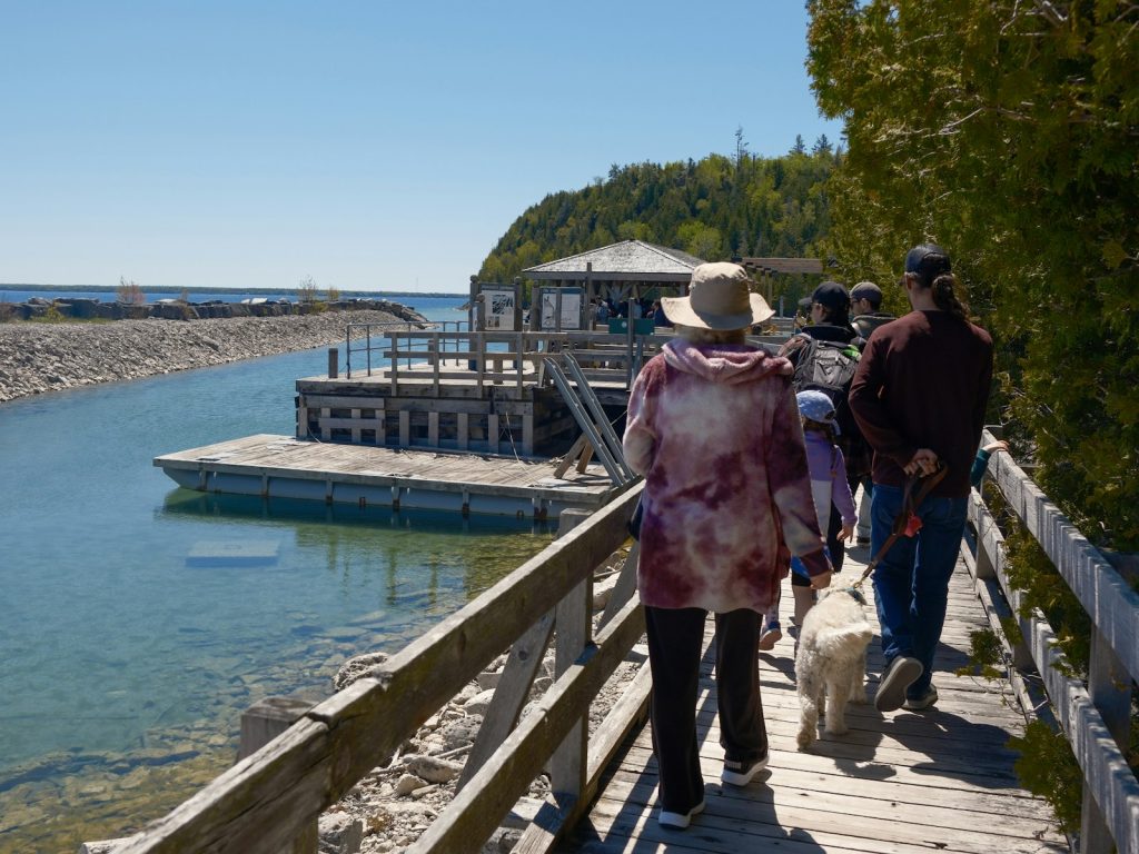 Walkers on a waterfront boardwalk, an easy outing during dementia home care in Boynton Beach