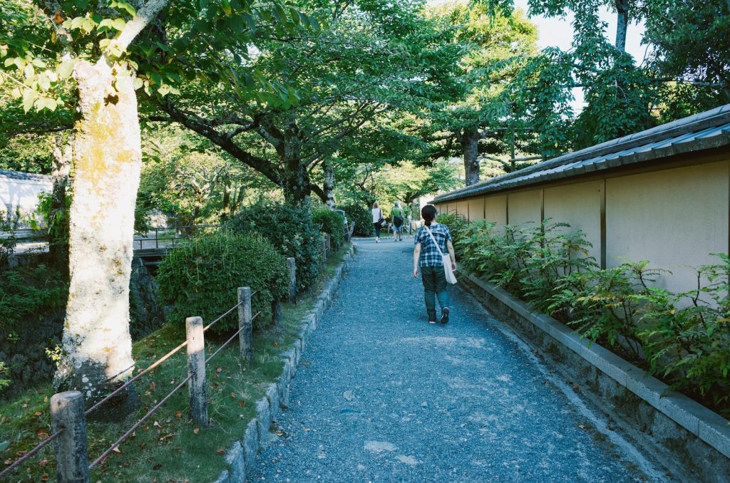 A companion providing dementia home care in Delray Beach, walking with an older man to a 55+ community clubhouse
