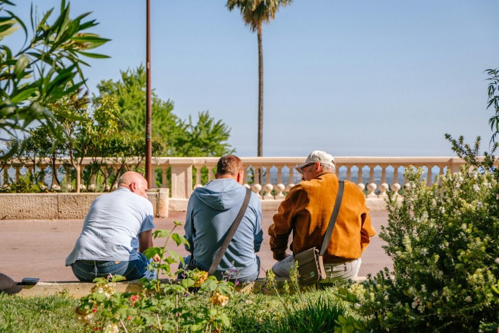 A son holding his mother's hand to communicate with a loved one who has dementia
